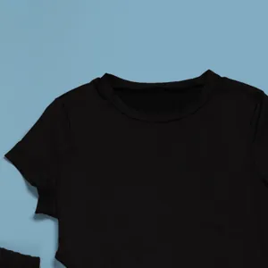 Close-up of a black short-sleeved tight-fitting top from a two-piece set on a blue background