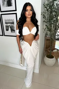 Full body view of white ruched two-piece set with V-waist skirt and crop top