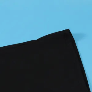 Detail view of the fine stitching and black elastic fabric of the midi skirt set