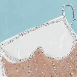 Dettaglio raffinato di un abito sexy in rete con decorazioni in perle e strass argento