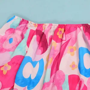 Close-up detail showing the vibrant multi-colored floral print on lightweight dress fabric