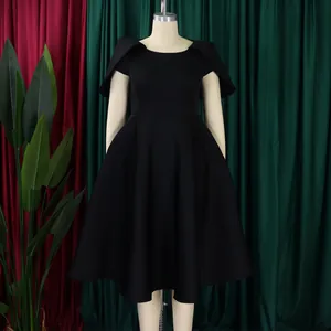 Front view of an elegant black cocktail dress with cape sleeves on a mannequin display