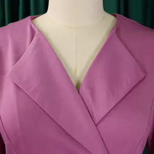 Close-up of elegant V-neckline detail on a purple solid color fashion dress.
