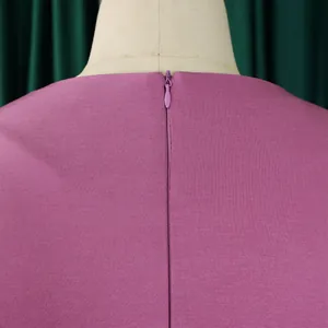 Close-up of the hidden back zipper on this elegant mauve high-waisted dress now