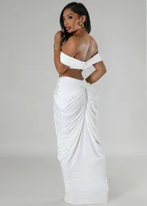 Detailed rear view of white elegant ruched maxi skirt and off-shoulder crop top set