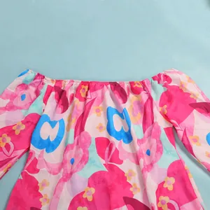 Detailed macro shot of a vibrant floral print dress featuring an off-shoulder neckline