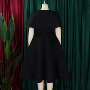 Back view of elegant black cape-style evening midi dress with large swing skirt