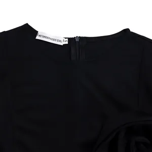 Detail shot of the neckline and brand label on an elegant black short sleeve dress