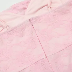Close-up detail of a pink floral lace dress showing the hidden zipper and straps.
