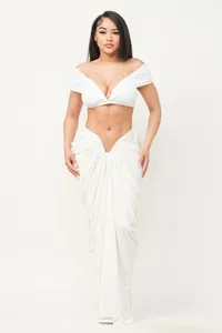 Sexy white two-piece set with strapless crop top and ruched floor-length maxi skirt.
