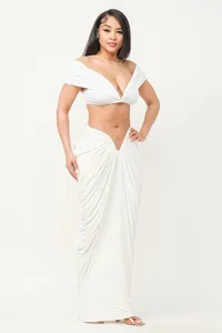 Full body view of a sexy white off-shoulder ruched crop top and long maxi skirt set