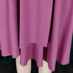 Detailed macro shot of an elegant purple dress with layered hem and ribbed texture