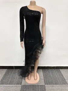 Detail view of black one-shoulder sequin dress with ruffled mesh hem on mannequin