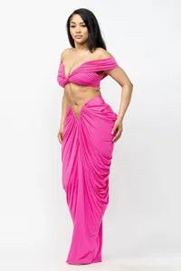 Elegant sexy pink two-piece set with off-shoulder crop top and draped maxi skirt