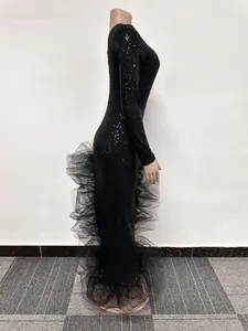 Elegant black sequin maxi dress with elaborate mesh ruffles viewed from a side profile