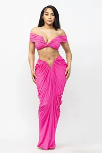 Sexy hot pink two-piece set featuring off-shoulder top and ruched floor-length skirt.