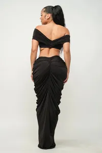 Detailed back view of a sexy black two-piece set featuring a ruched floor-length skirt.