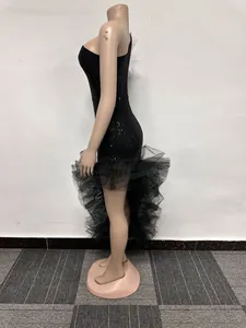 Full side view profile of black one-shoulder sequin dress with ruffled mesh hemline