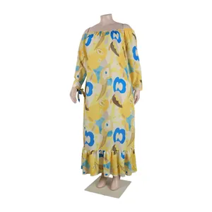 Detailed view of the yellow floral pattern and ruffled hem on this plus-size maxi dress.