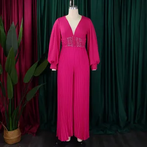 Elegant fuchsia pleated wide-leg jumpsuit with beaded waist and balloon sleeves on mannequin