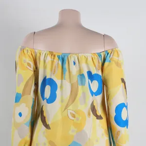 Detail view showing the back of a vibrant yellow and blue floral off-shoulder dress