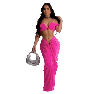 Sexy hot pink two-piece set featuring off-the-shoulder crop top and draped floor-length skirt