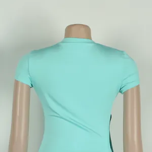 Detailed back view of turquoise tight-fitting short-sleeved dress shown on a mannequin
