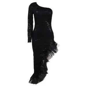 Close-up of elegant black one-shoulder sequin dress with ruffle mesh hem detail