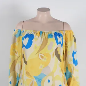 Detailed view of the off-the-shoulder elastic neckline on a vibrant floral print dress