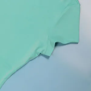 Close-up view of the seam and fabric texture of a mint green elastic bodycon dress.