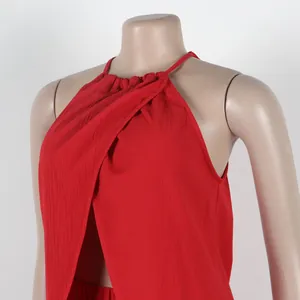 Detailed macro view of red textured halter neck sleeveless top with front slit.