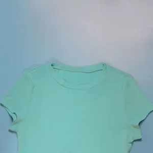 Close-up detail of the mint green round neck top from a two-piece stretch dress set