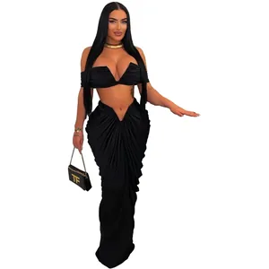 Full-length view of black two-piece set with strapless crop top and draped maxi skirt
