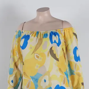 Close-up of off-shoulder floral print dress with vibrant yellow and blue patterns