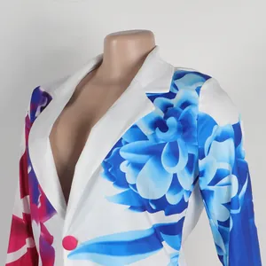 Detailed macro view of vibrant blue and pink floral patterns on a white fashion blazer