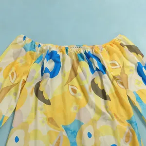 Close-up of vibrant floral off-the-shoulder blouse with elastic neckline detail