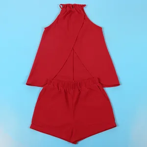 Flat lay view of red halter neck top with cross slit back and matching shorts set