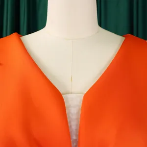 Close-up detail showing the elegant V-neck design of this orange formal evening party gown