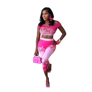Detailed studio shot of women's pink floral print crop top and high-waist pants set