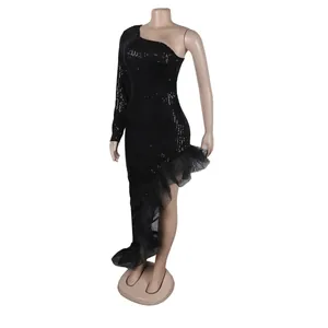 Detail view of black sequined one-shoulder dress with ruffled mesh hem on mannequin