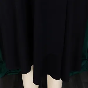 Detailed close-up view of the elegant black maxi dress hem showing smooth fabric drape