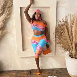 Close-up view of the vibrant floral print off-shoulder crop top and leggings set