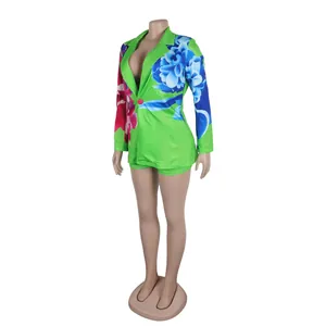 Vibrant green floral print blazer and shorts set on mannequin