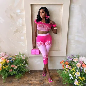 Close-up of a vibrant pink floral print two-piece set with crop top and leggings