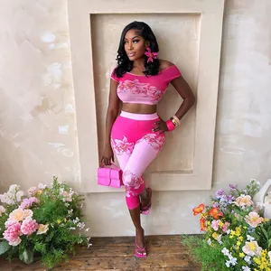Model showcasing pink floral off-shoulder crop top and high-waisted leggings set