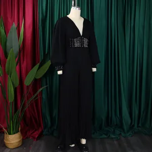 Elegant black beaded V-neck jumpsuit with wide-leg design and mesh sleeve details.