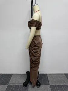 Detailed side view of a brown ruched crop top and maxi skirt two-piece set on mannequin
