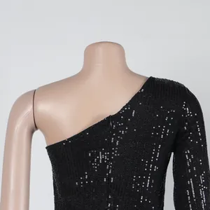 Detail view of shimmering black silver sequined one-shoulder dress texture