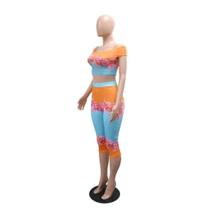 Side view of floral print two-piece set with off-shoulder top and high-waist leggings