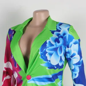 Detail view of vibrant green floral print blazer with deep V-neckline and notched lapel